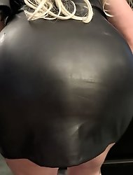 A girl is smoking in a new red leather dress and showing her body